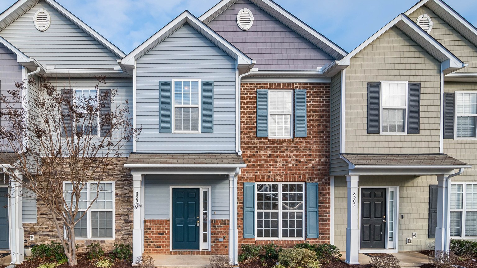 Connected multi-unit townhomes with shared pitched rooflines