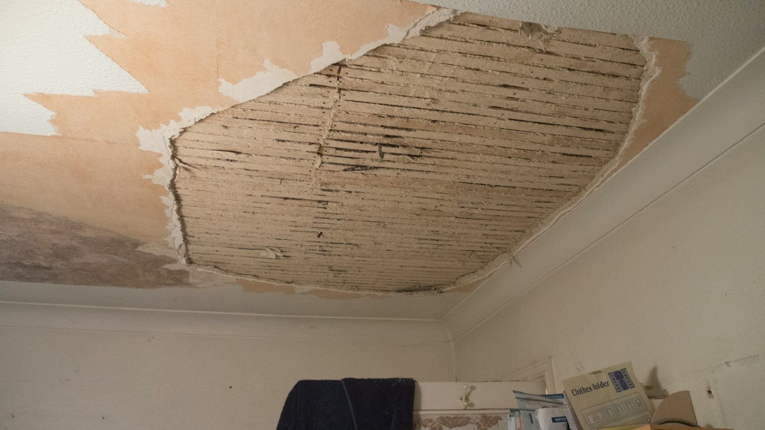 Interior ceiling opened after extensive water damage from a roof leak
