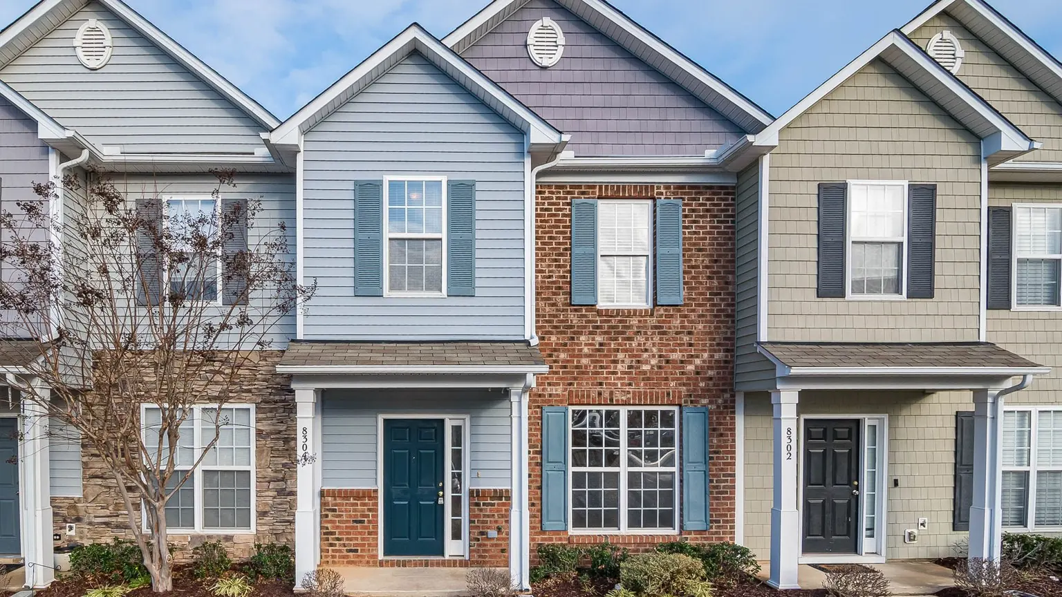 Connected multi-unit townhomes with shared pitched rooflines